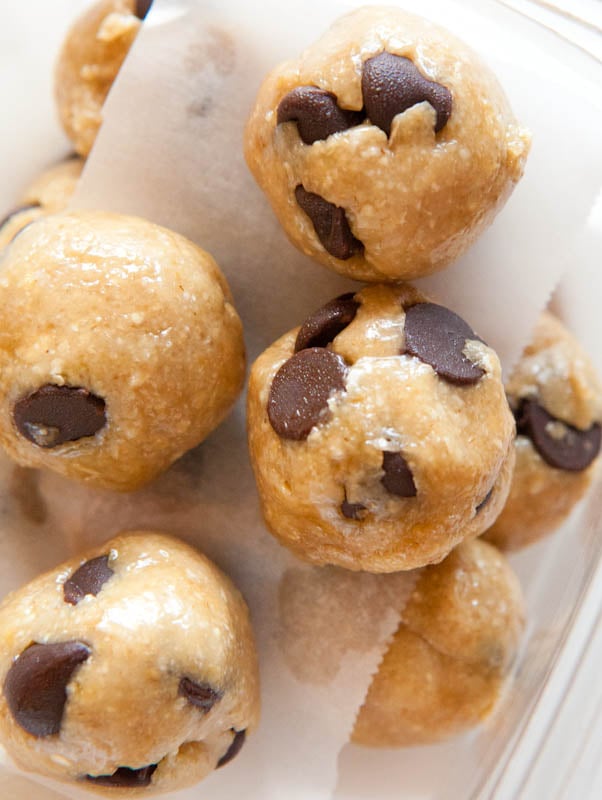 Raw Vegan Chocolate Chip Cookie Dough Balls stacked in clear container