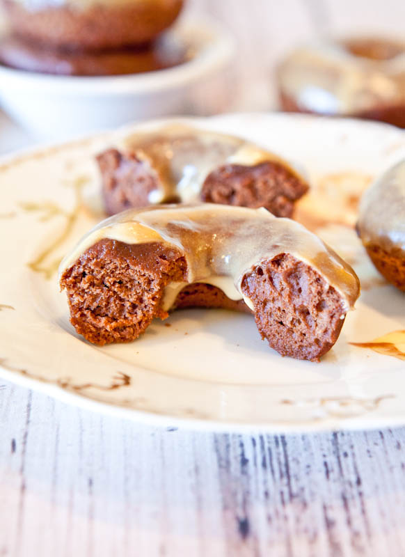 Split Baked Chocolate Peanut Butter Donuts with Vanilla Peanut Butter Glaze on plate