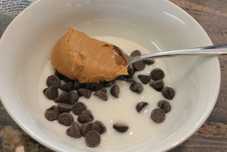 Peanut butter, chocolate chips and milk in bowl