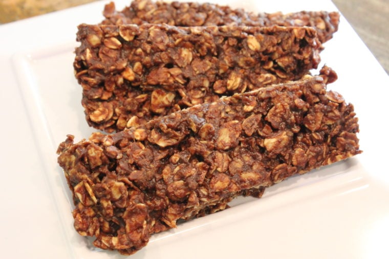Three No Bake Chocolate Peanut Butter & Oat Snack Bars on white plate