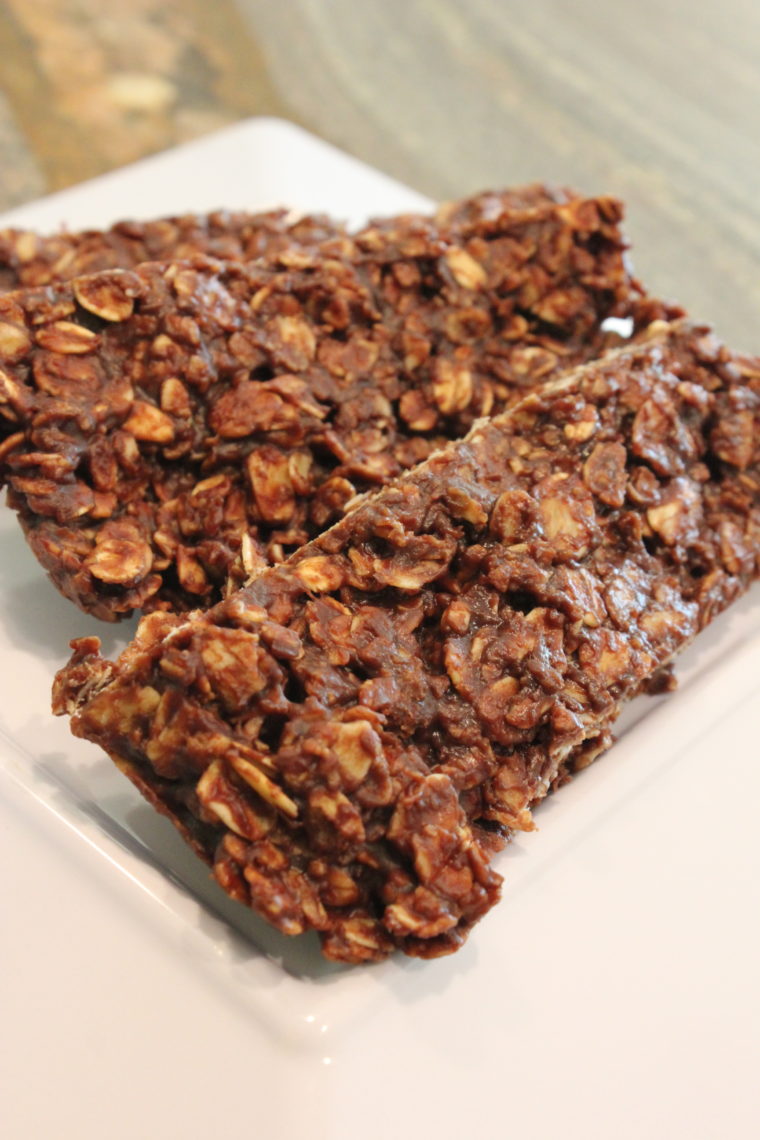 Three Microwave Chocolate Peanut Butter & Oat Snack Bars stacked on white dish