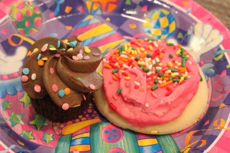 Chocolate mini cupcake and cookie on birthday plate