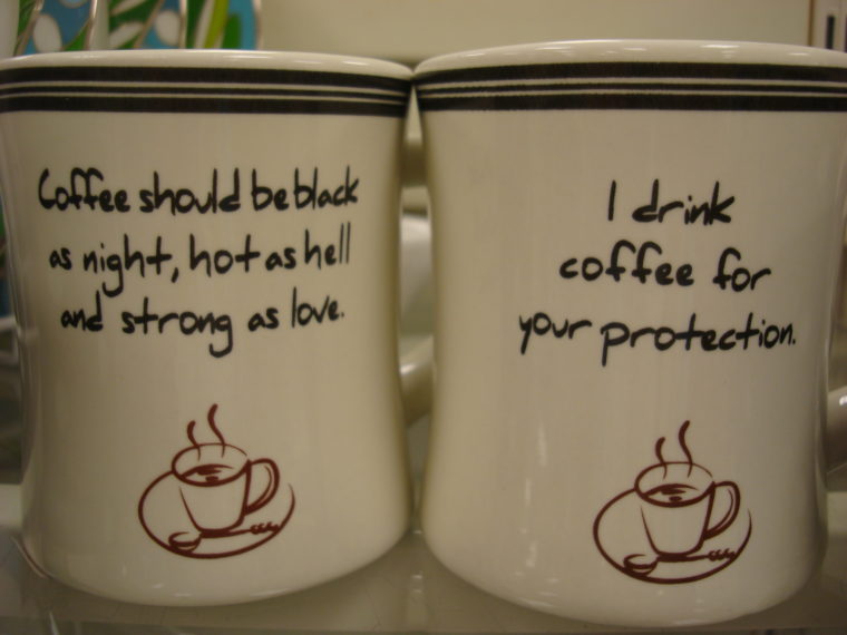 Two coffee mugs with various sayings