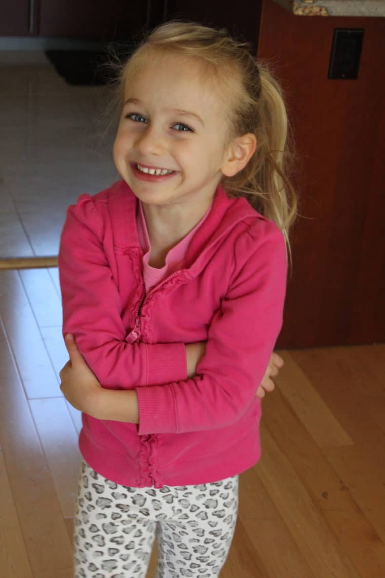 Young girl smiling with arms crossed