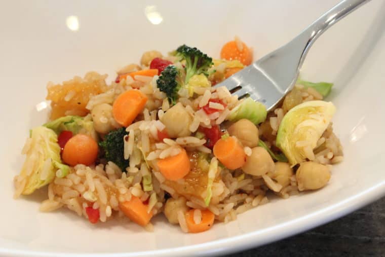 Mango Balsamic Rice, Beans & Vegetables in white bowl with fork