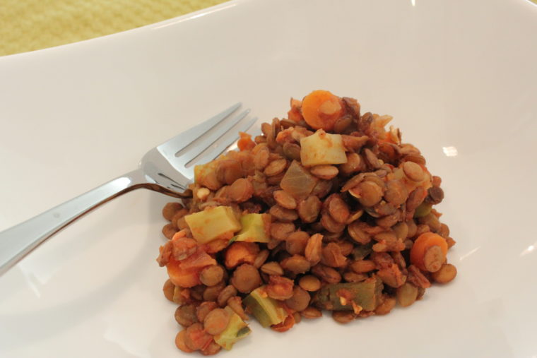 Chipotle Salsa Lentils with Mixed Vegetables in white dish with fork