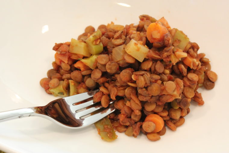 Fork digging into Chipotle Salsa Lentils with Mixed Vegetables
