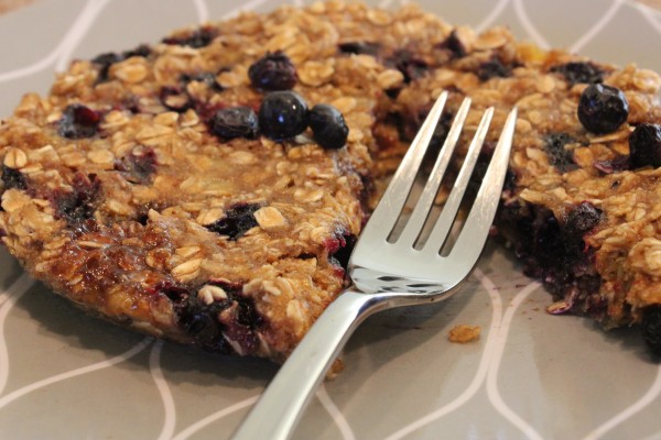 Slice missing out of Microwave Blueberry Banana Oat Cake with fork on plate