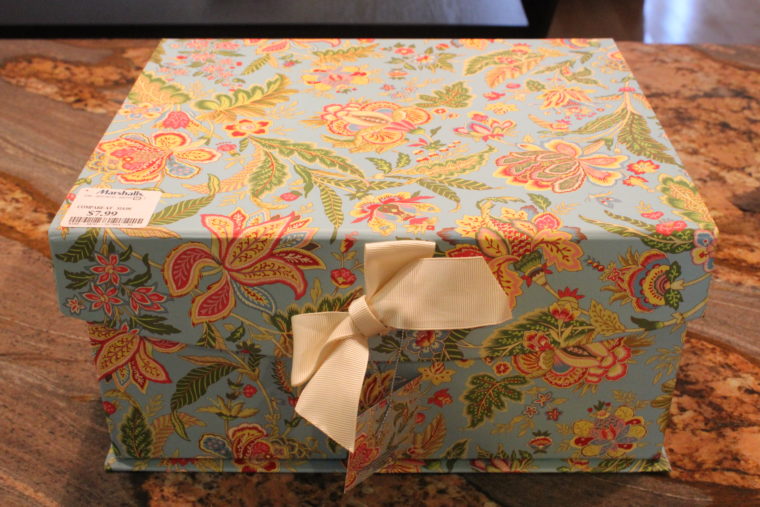 Multi colored flowered box with white bow