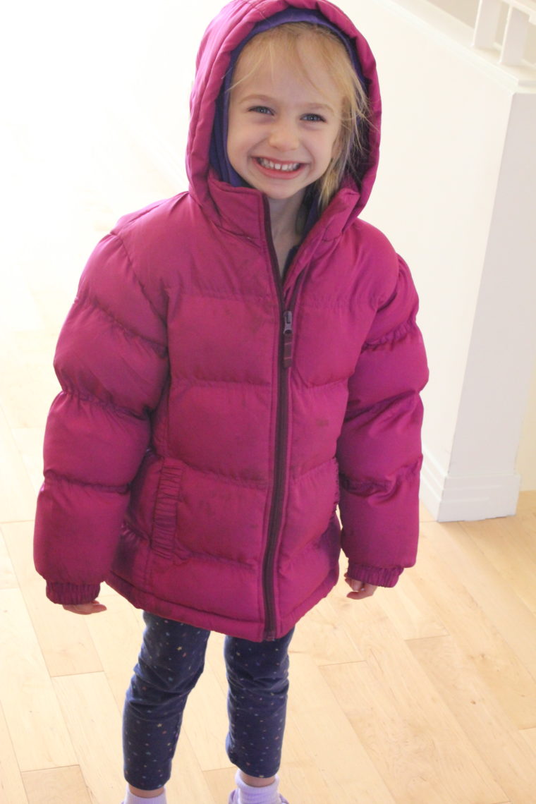 Young girl wearing puffy jacket smiling
