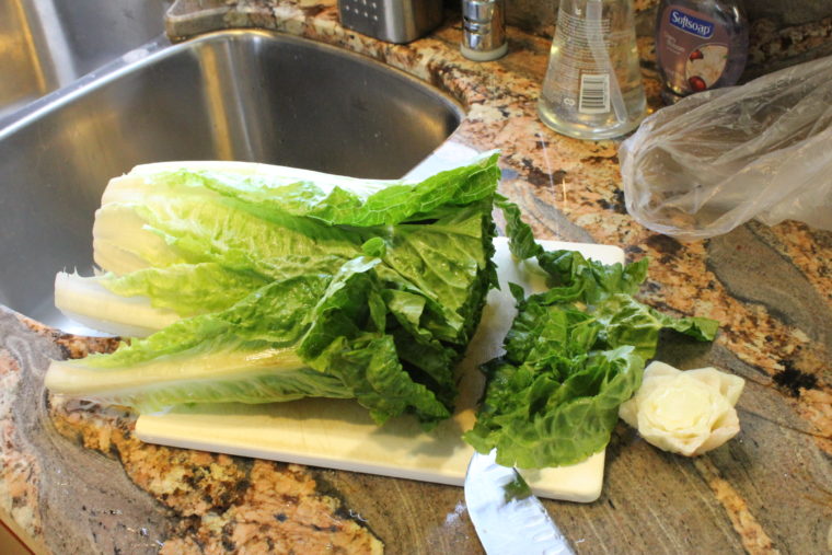 Lettuce being chopped up on cutting board