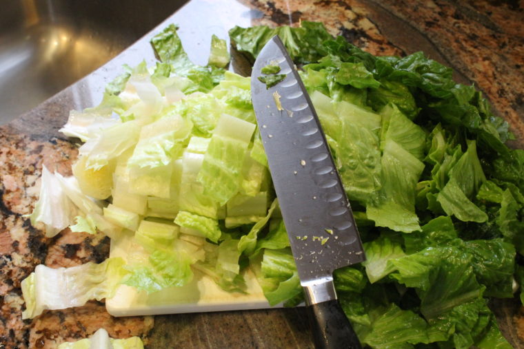 Chopped lettuce on cutting board with knife