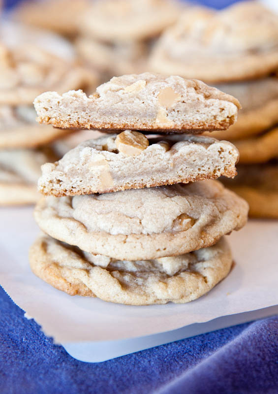 Puffy Vanilla and Peanut Butter Chip Cookies stacked on parchment paper