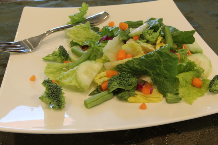Eye level of salad on plate with fork