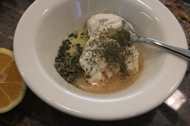 Ingredients for Creamy Lemon Herb Dip in bowl with spoon