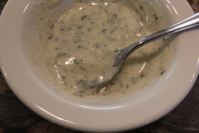 Vegan Creamy Lemon & Herb Dressing in bowl with spoon