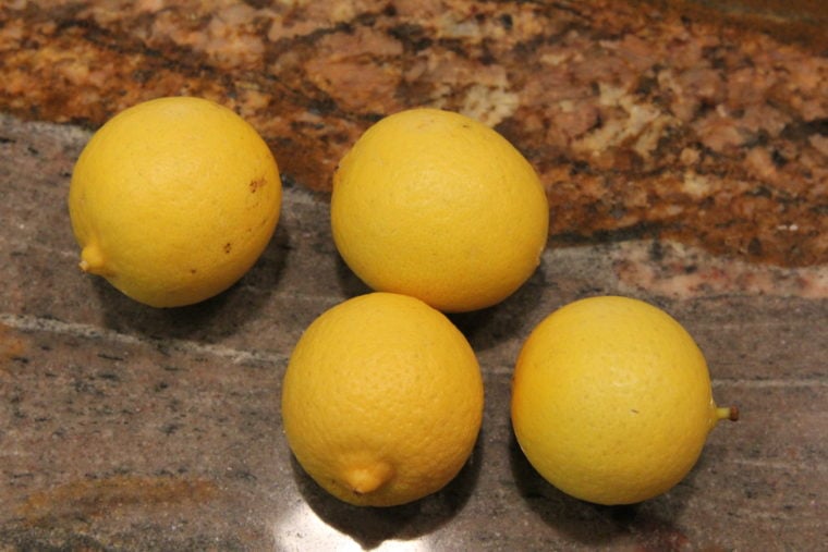 Four lemons on countertop