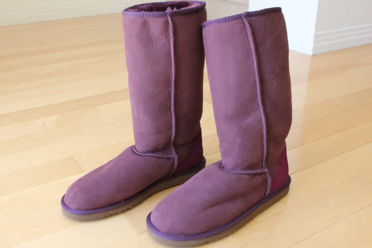 Purple colored boots on floor