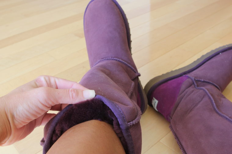 Boots being worn with hand folding down top