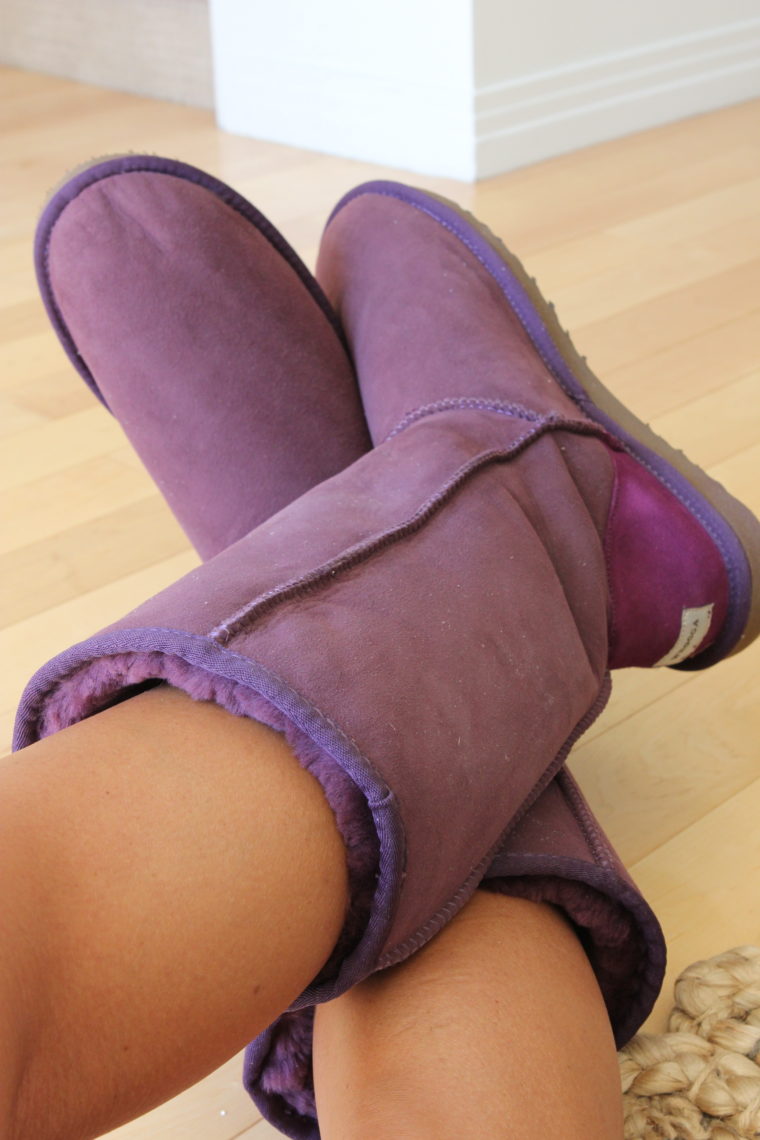 Legs crossed with purple boots on