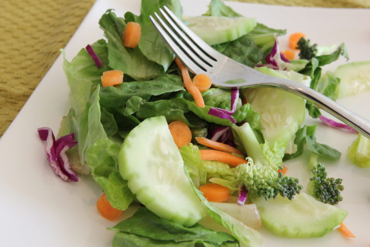 Green salad with vegetables on plate with fork