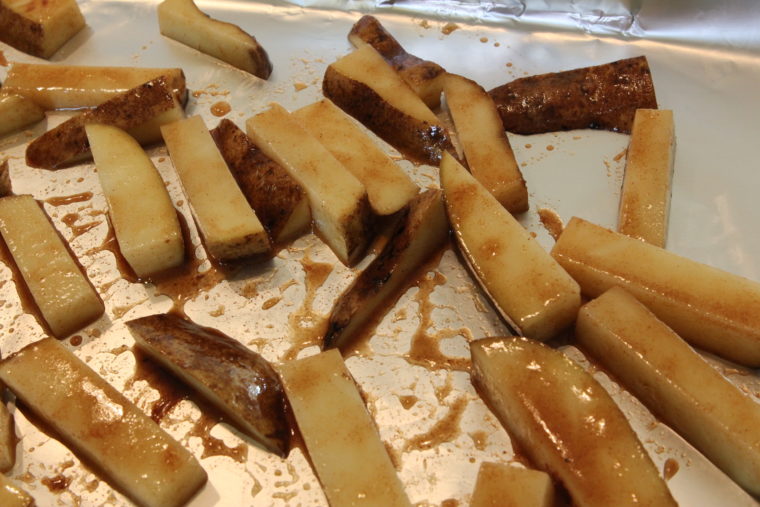 Cinnamon-Sugar and Ginger-Roasted Potato Sticks on foil lined pan