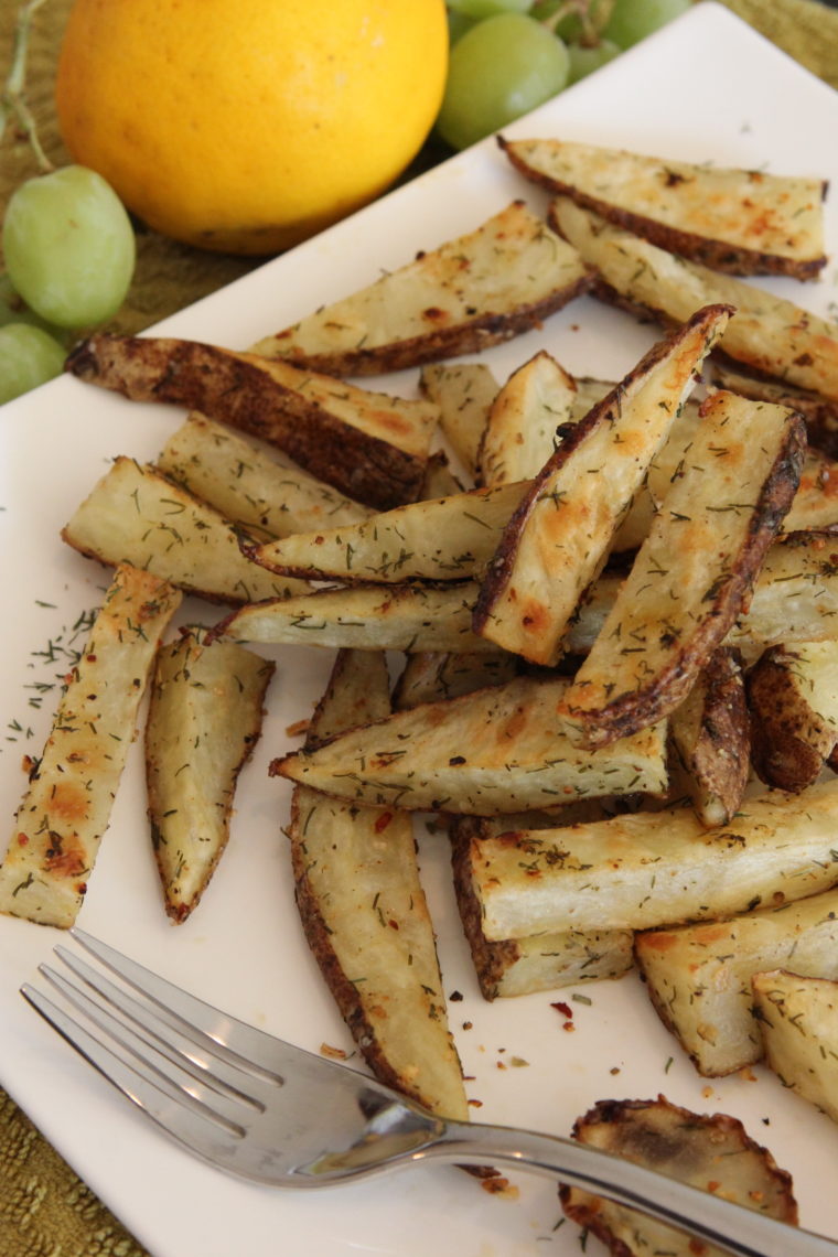 Close up of plated Lemon & Dill Roasted Potato Sticks with fork