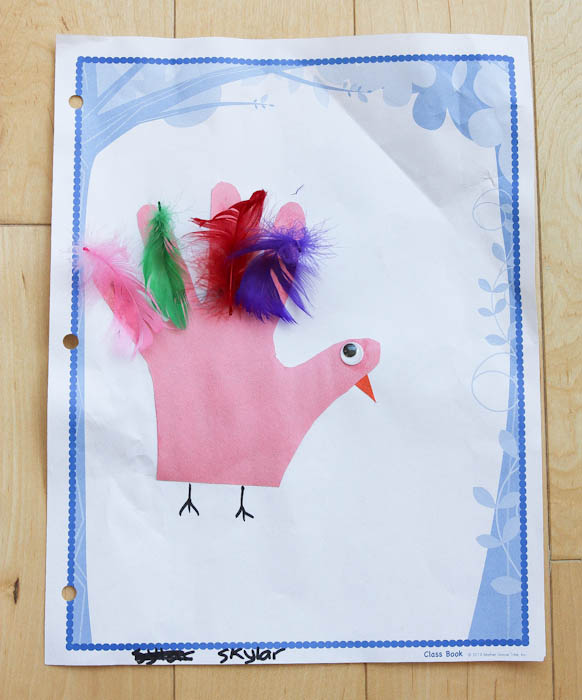Young girls artwork with hand with feathers and a bird face
