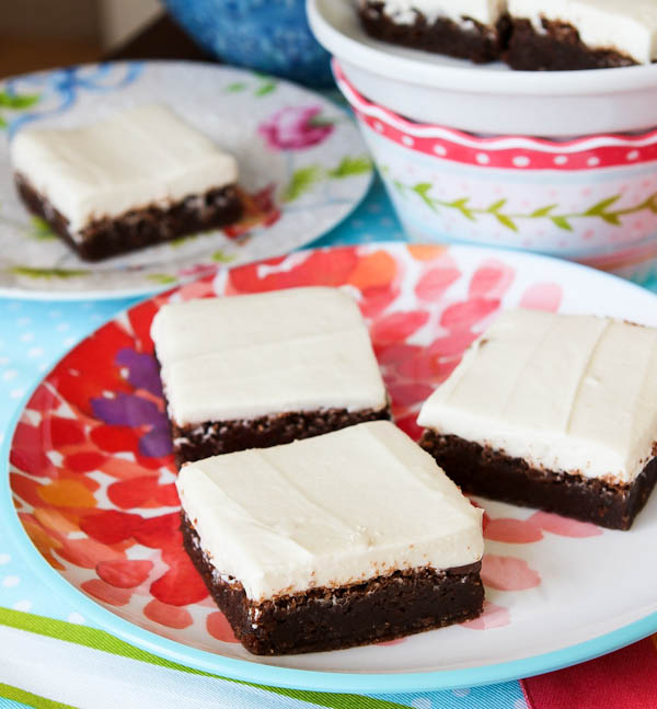 Three Fudgy Nutella Brownies with Cream Cheese Frosting on plate