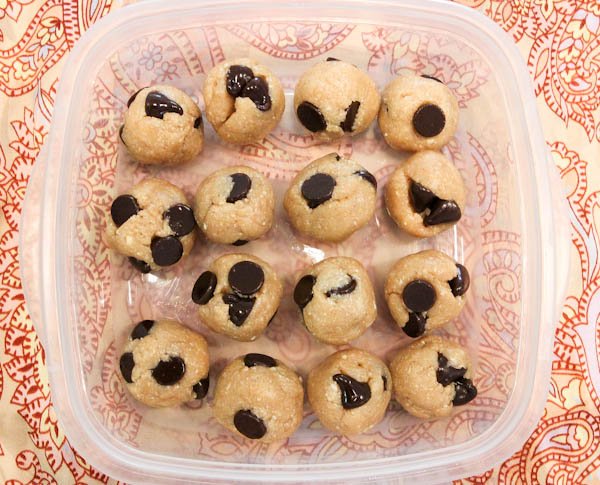 Overhead of Raw Vegan Chocolate Chip Cookie Dough Balls in clear container 