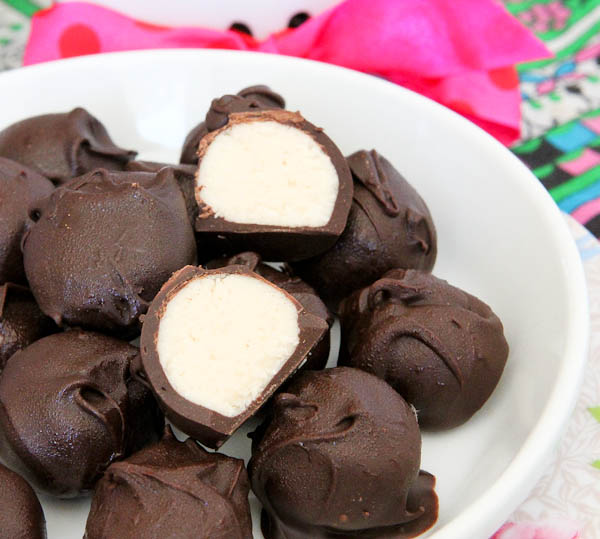 Close up of No-Bake Vanilla Cake Batter Chocolate Truffles with one split open showing inside