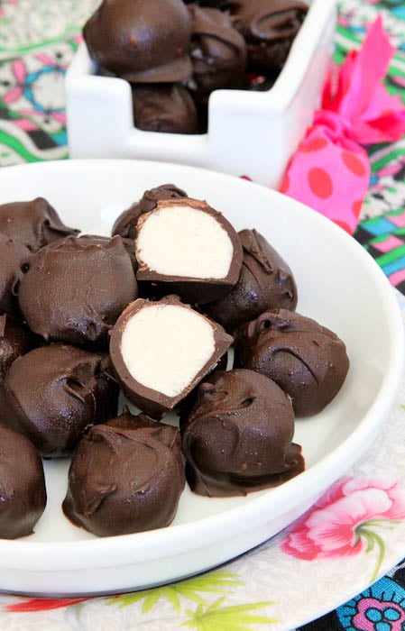 No Bake Vanilla Cake Batter Chocolate Truffles on white dish with one split in half showing inside