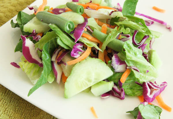 salad with snap peas, cucumbers, cabbage, and carrots