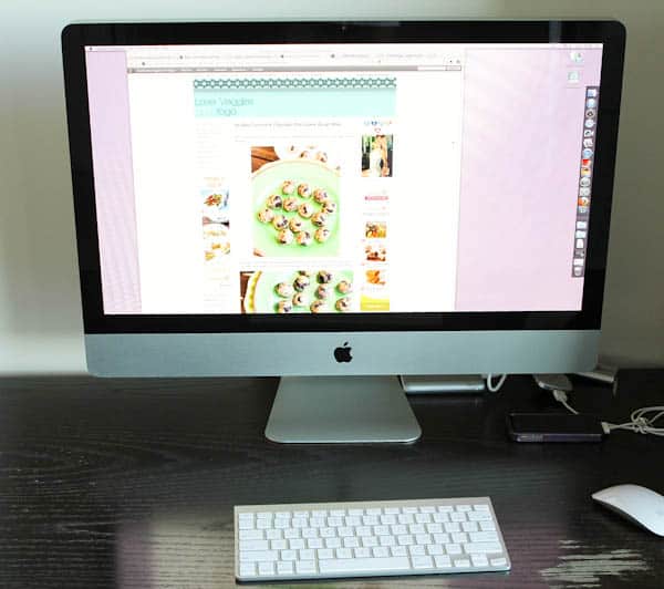 Apple desktop computer with Love Veggies and yoga website front page pulled up