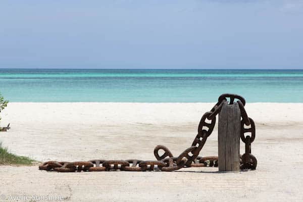 Aruba beach with chains falling off post