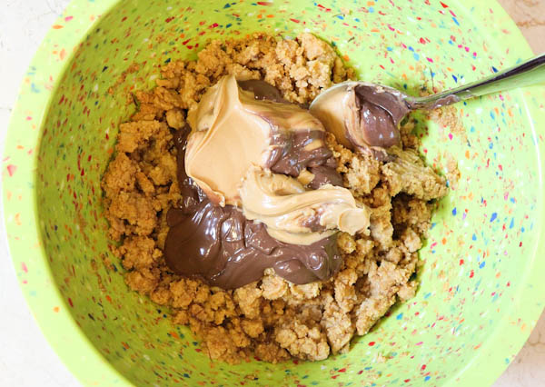 Honey Maid Graham cracker crumbs with peanut butter and nutella in bowl