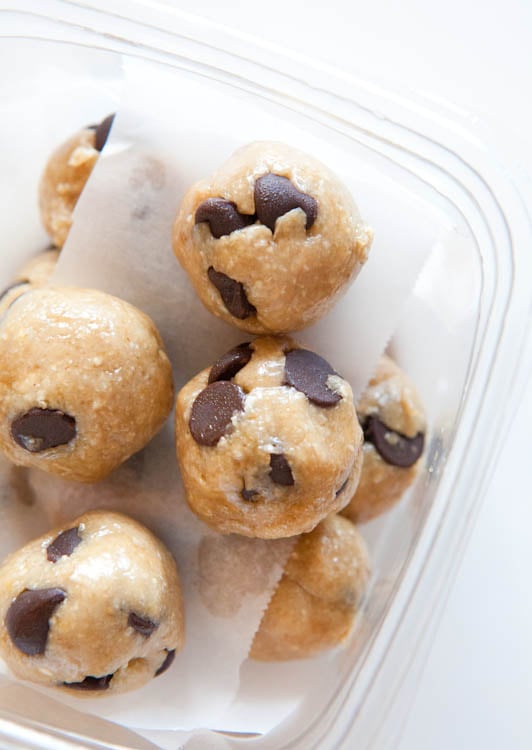 Overhead of Raw Vegan Chocolate Chip Cookie Dough Balls in clear container