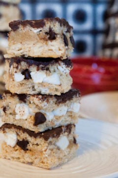 Three plates stacked with Marshmallow Stuffed Rice Krispie Bars