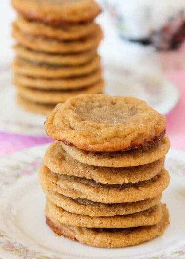 Stacks of golden-brown cookies on a plate.