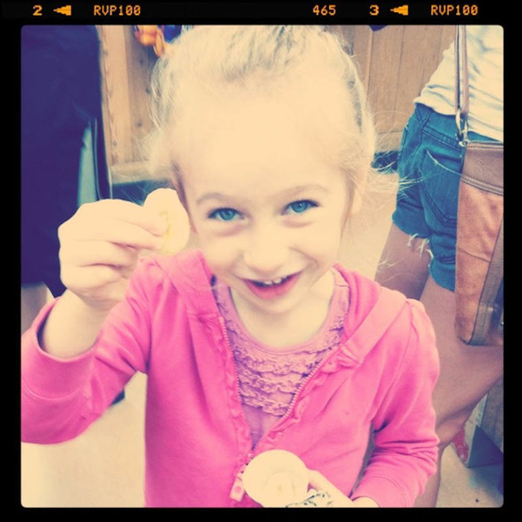 Close up of young girl holding snack