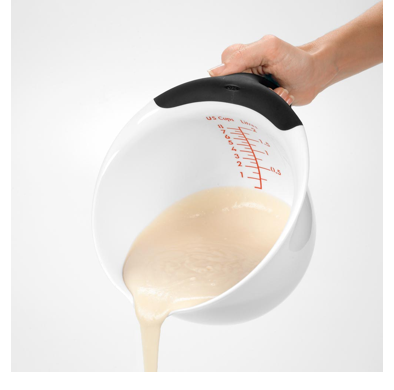 batter being poured from batter bowl with black handle