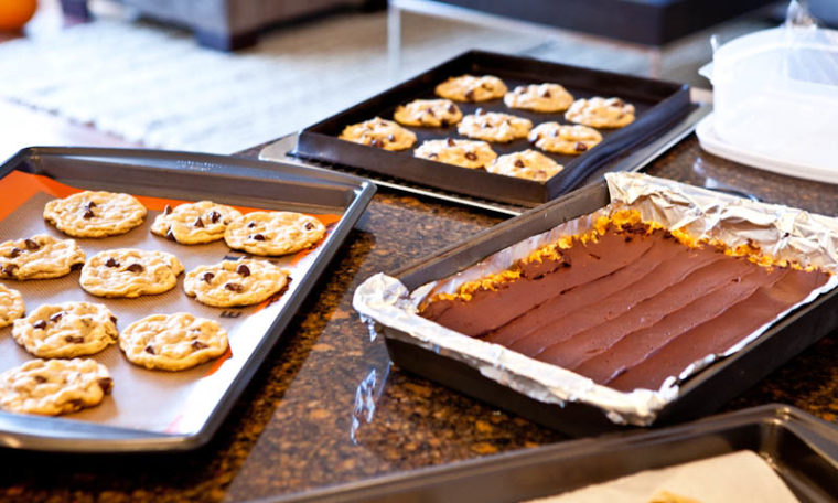 Pans of cookies and bars on marble counter