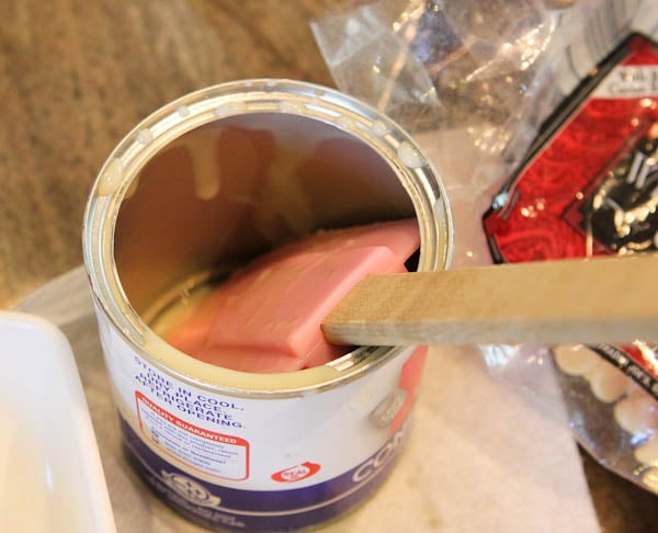 Open empty can of Condensed sweetened milk with pink spatula in it
