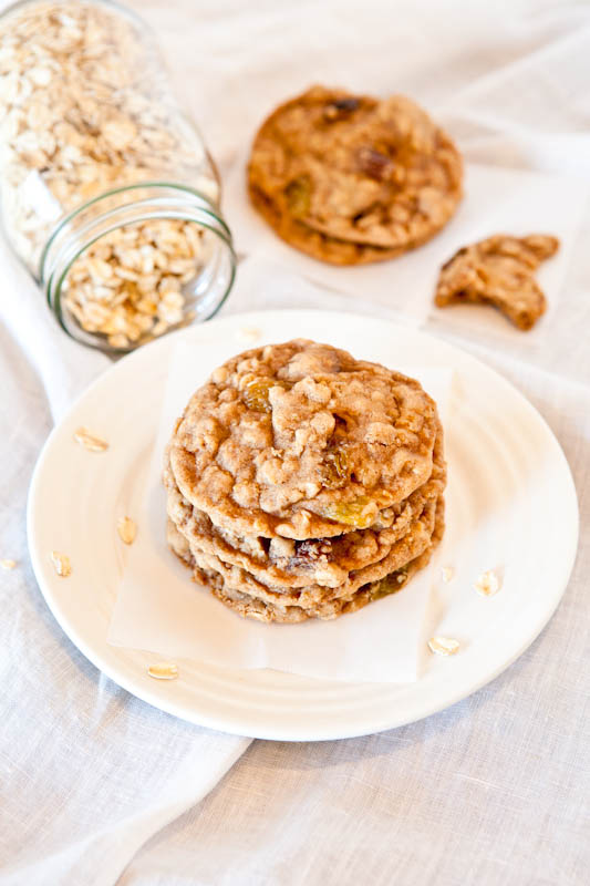 Oatmeal cookies stacked with jar of oats in the background