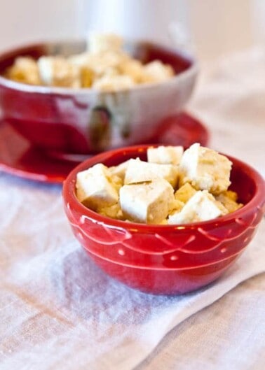 Bowls of cubed tofu on a table.
