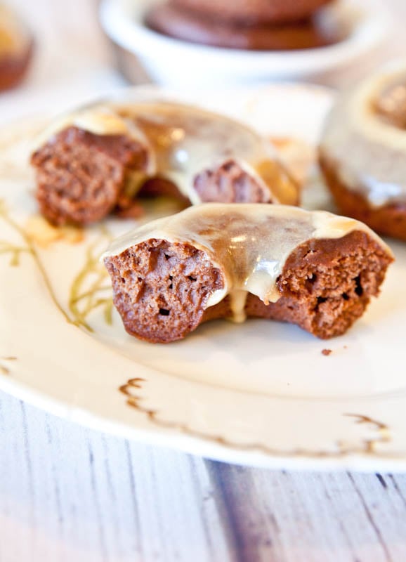 Cut in half Baked Chocolate Peanut Butter Donuts with Vanilla Peanut Butter Glaze