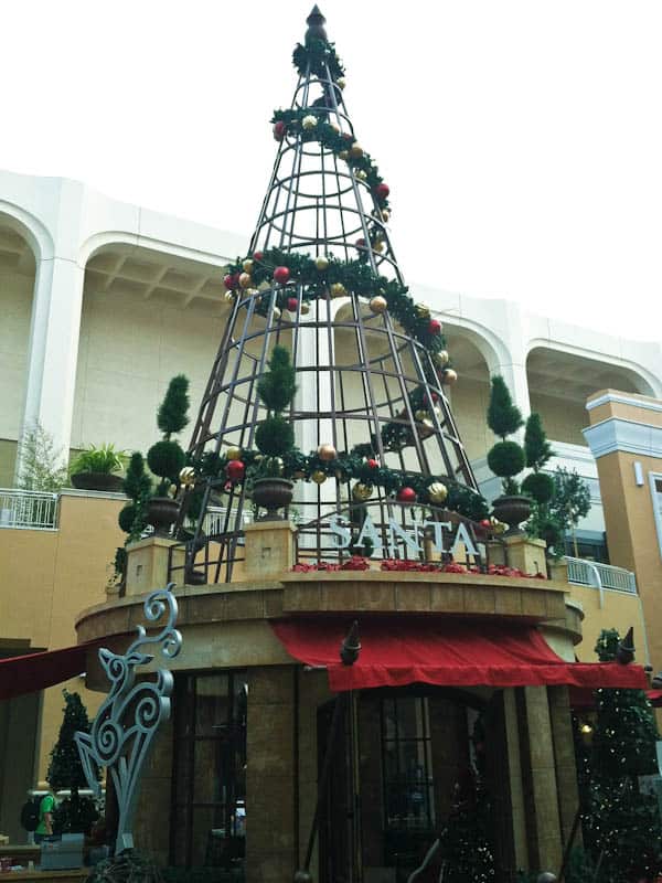 Wire Christmas tree display with garland spun around it
