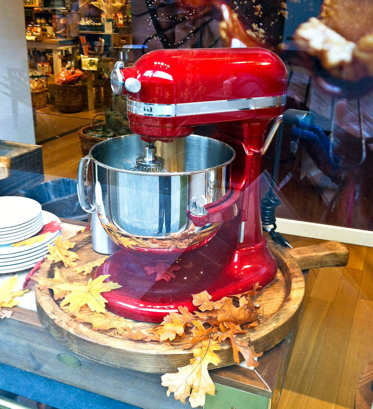 Red Kitchen aid mixer on wood platter