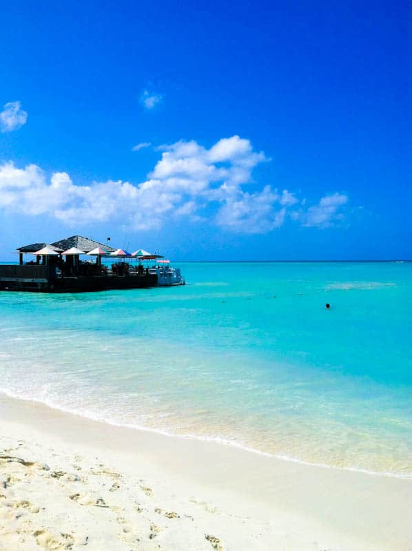 Aruba beach with dock and umbrellas