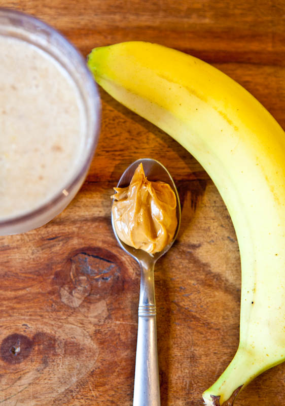 Banana, spoon of cookie butter and smoothie